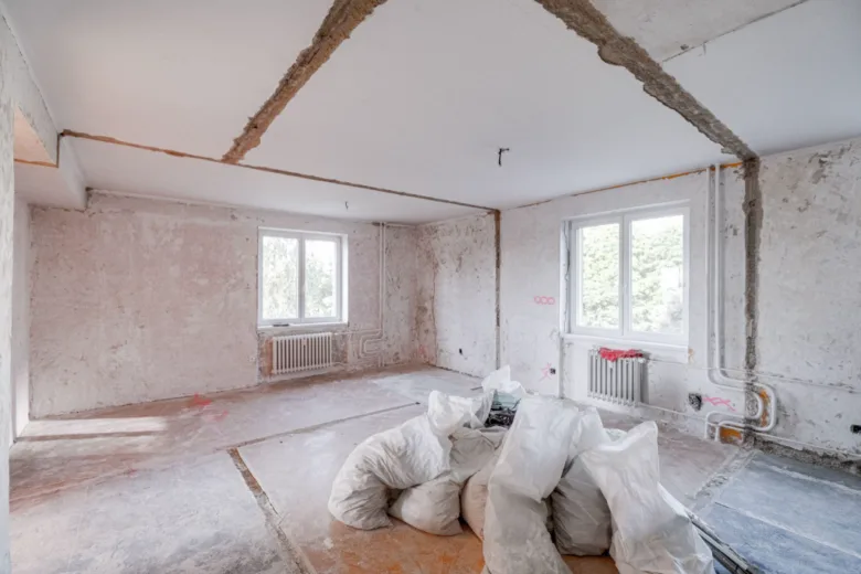 Prázdný byt v rekonstrukci s odvozenými stavebními materiály.