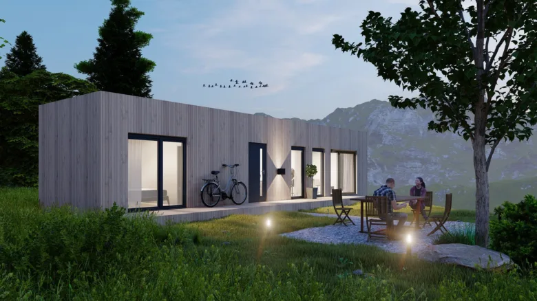 Moderní modulový dům v horské krajině s venkovním posezením.